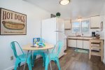 Pool house kitchen is basic and has dining space for four